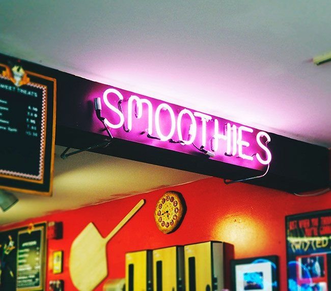 Custom neon sign glowing in a dark interior