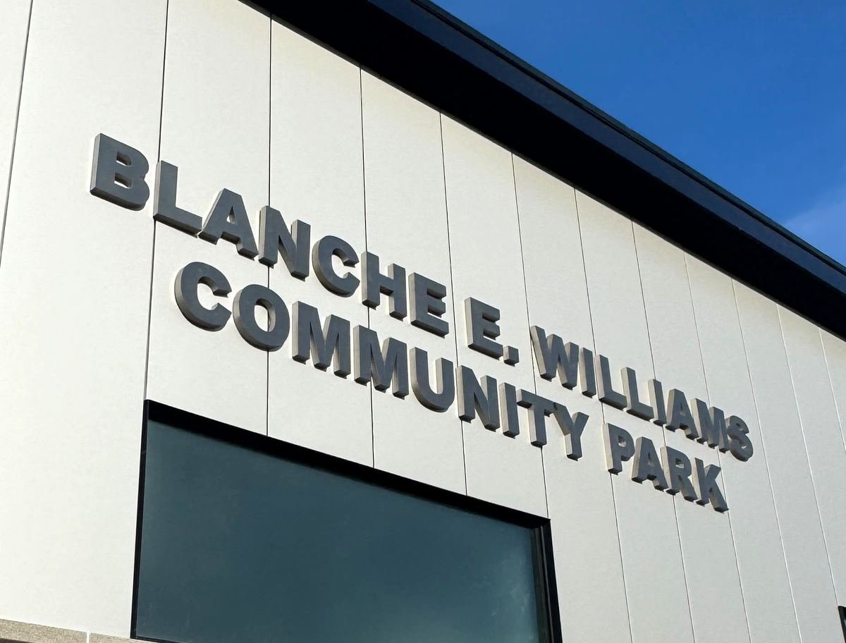 Dimensional cut-out letters reading Blanche E. Williams Community Park on building facade